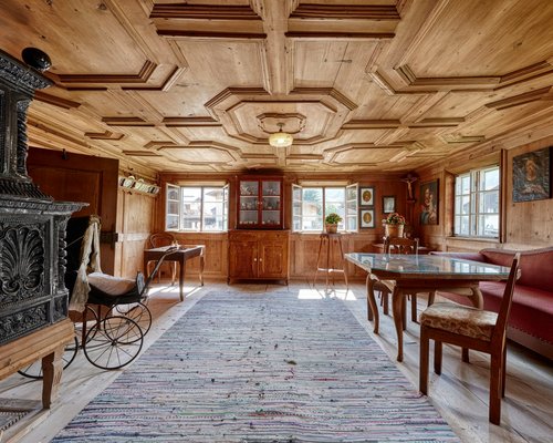 Hotel Sonnenhof Rustikaler Raum mit Holzverkleidung, antiker Möbel und Gemälden an der Wand