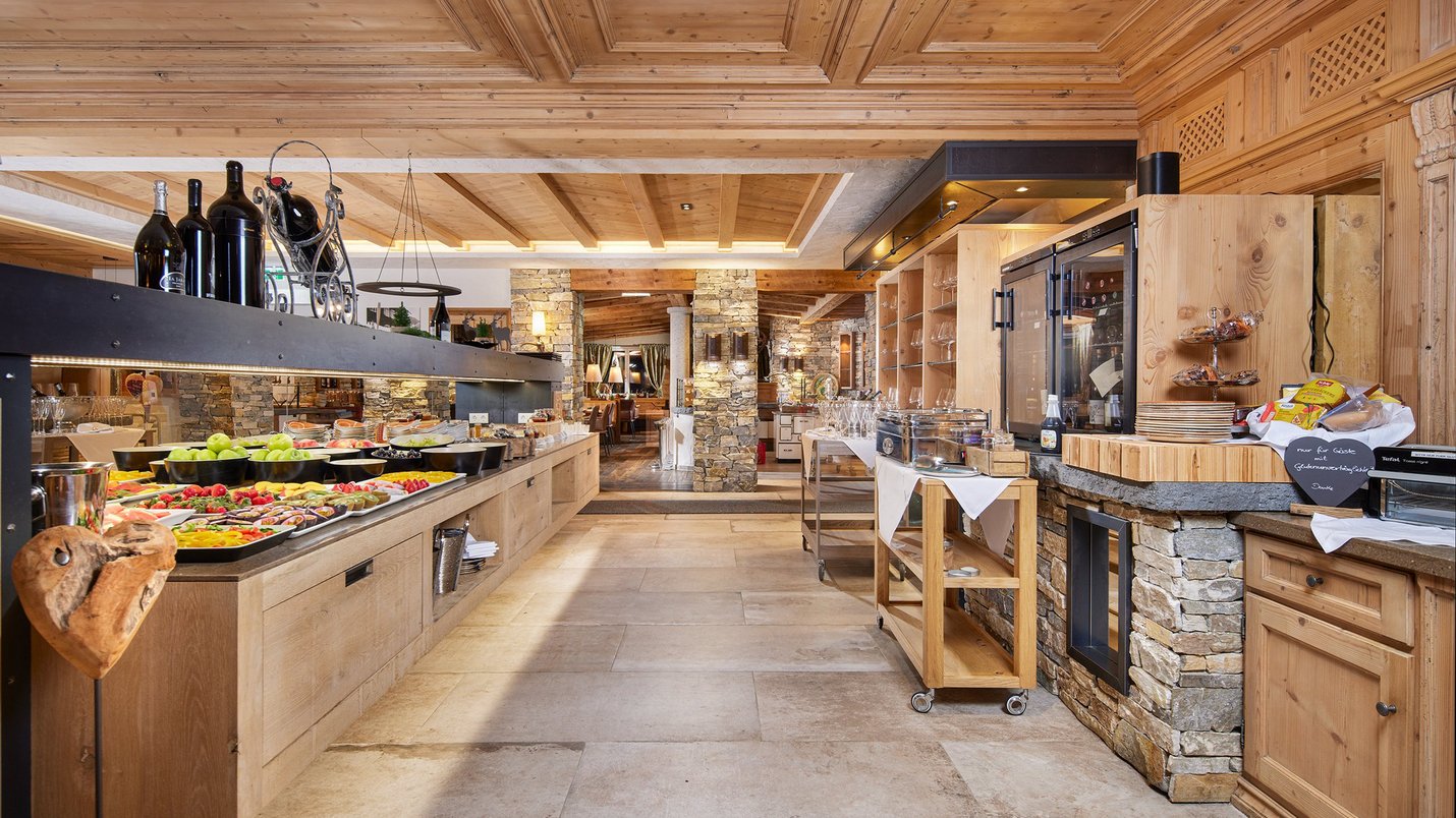 Hotel Sonnenhof Gemütliches rustikales Buffet mit Holzdecke und Steinmauern in einem Restaurant
